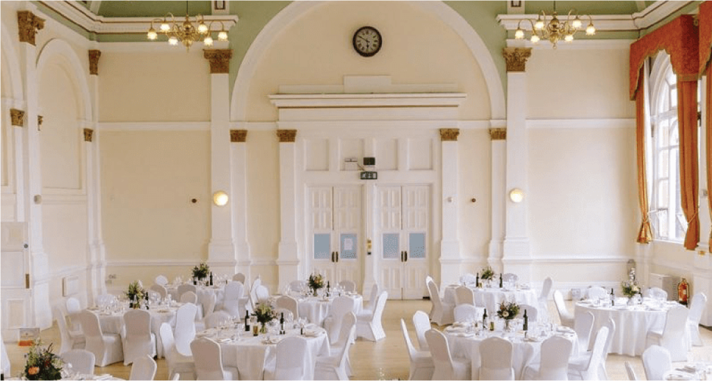 Wedding venue banqueting hall interior with tables set for a reception