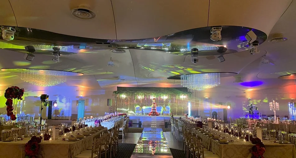Banquet hall interior with colourful lighting and long banquet tables