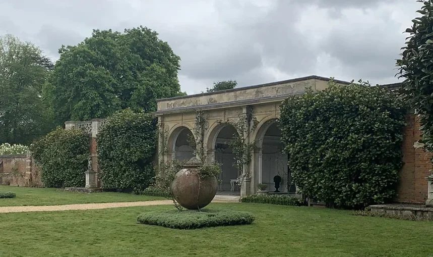 Stone archway building at North Mymms Park with a garden lawn."