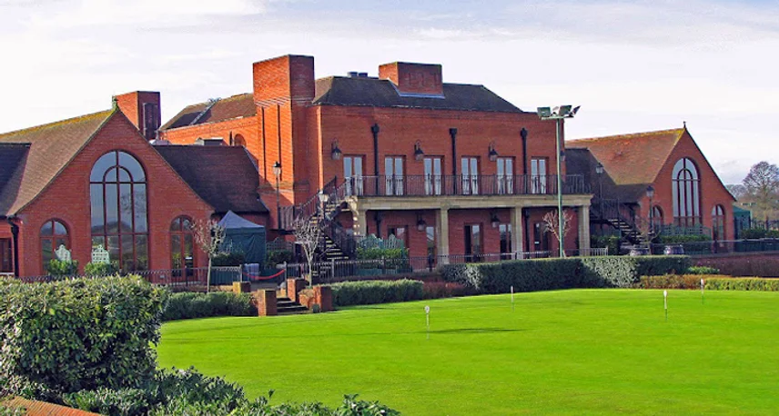 Red brick manor house venue exterior with landscaped lawn