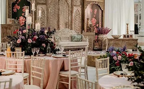 Elegant wedding venue table setting with pink floral accents