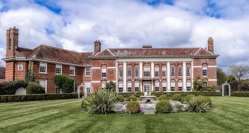 Red brick wedding venue exterior building surrounded by lawn