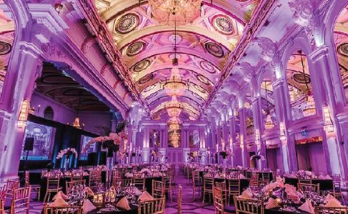 Wedding venue corridor lined with pink-lit chandeliers