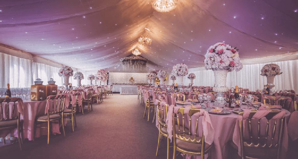 Wedding marquee interior lit in soft pink tones