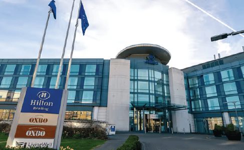 Modern hotel wedding venue exterior with flagpoles at the entrance