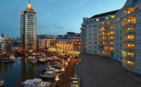 Riverside wedding venue apartments and boats illuminated at night