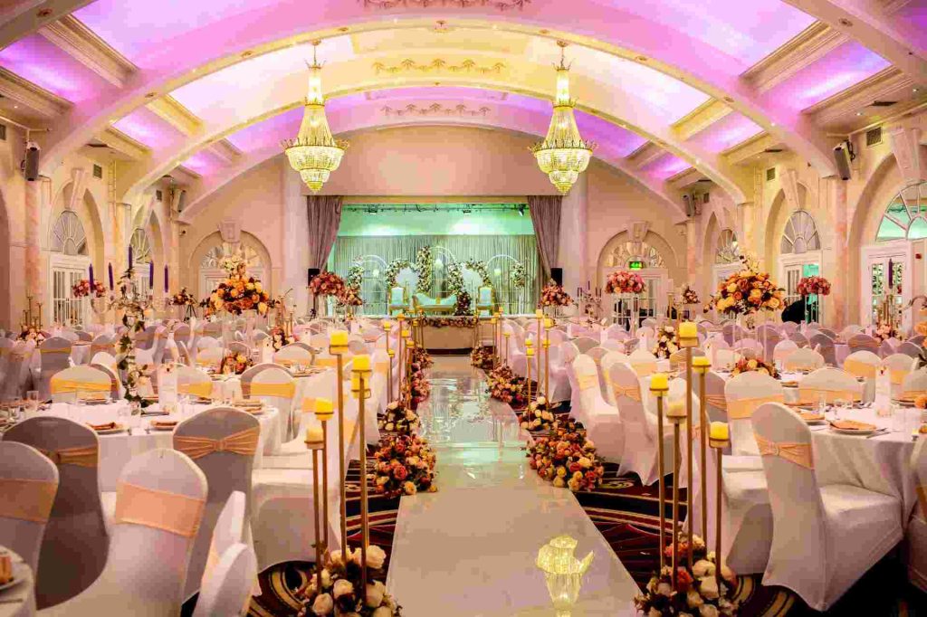 banquet hall pink lighting floral aisle