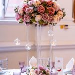 Wedding table centrepiece with a candelabra and mixed floral arrangement