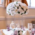 White floral centrepiece styled on a round wedding table