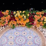 Zoom in Wedding stage with purple and gold floral arch backdrop