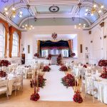 Wedding stage with a multi-tier floral arch backdrop