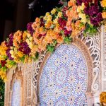 Wedding stage with an arched red rose backdrop