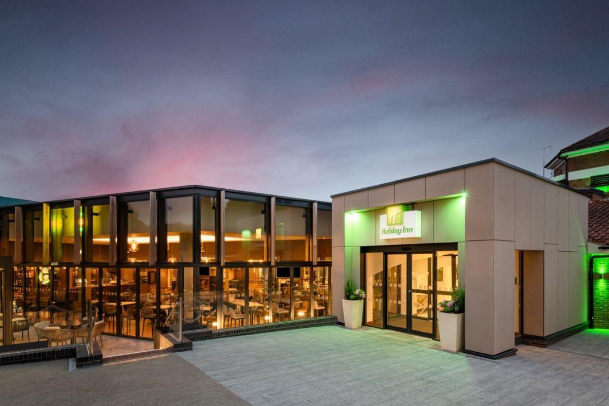 Modern venue building exterior illuminated at dusk