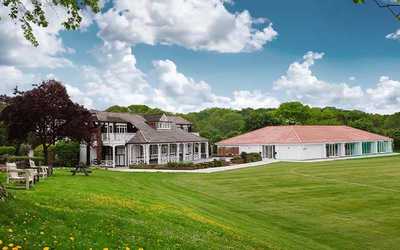 London Shenley Club (Marquee) 1 White venue building exterior with a large lawn and trees