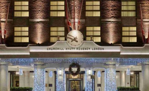 Churchill Hyatt Regency London hotel entrance illuminated at night