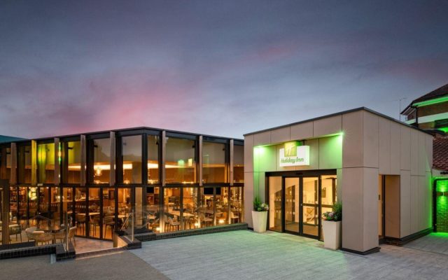 Modern venue building exterior illuminated at dusk