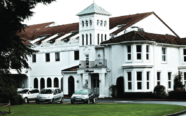 White wedding venue building exterior with a turret feature, viewed in daylight